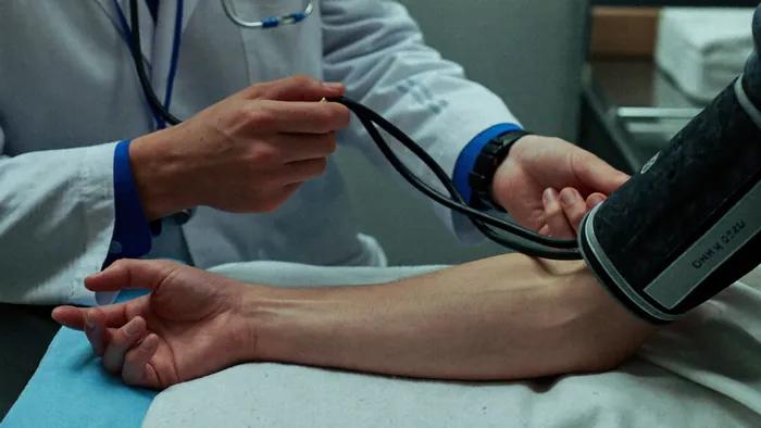 Blood pressure cuff applied by a clinician
